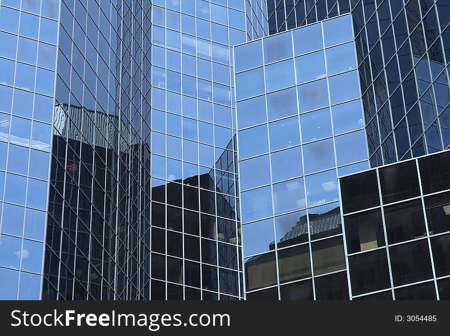 Reflections in a modern glass-windowed office building. Reflections in a modern glass-windowed office building.