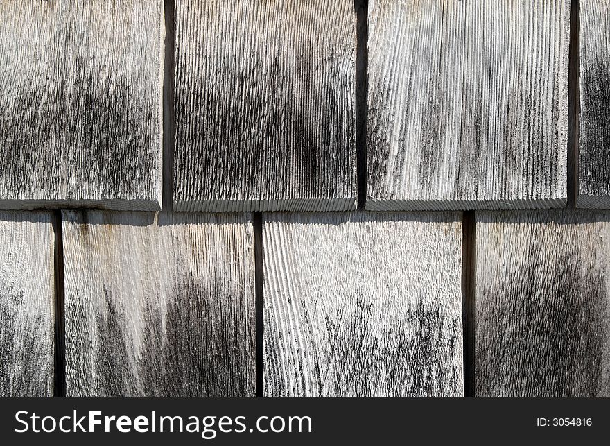 Gray wooden tiles background. Detail of a house wall.