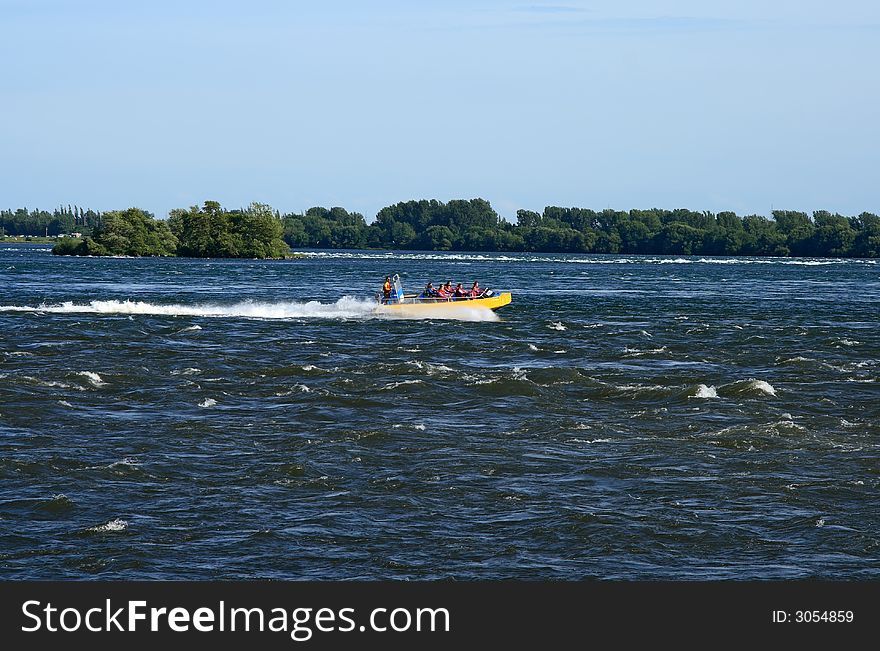 Tourists in a jet boat in a rapid stream. Tourists in a jet boat in a rapid stream.