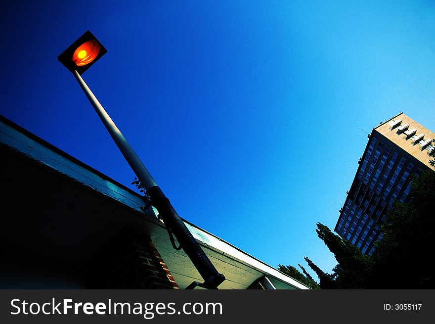 Lamppost working during daylight with blue sky in background. Lamppost working during daylight with blue sky in background