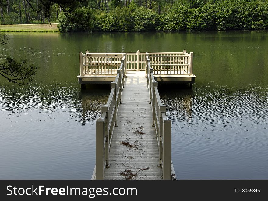 A walkway to a secluded platform on the lake. A walkway to a secluded platform on the lake