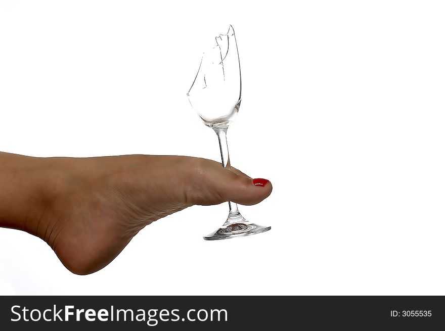 Female foot holding broken glas. Female foot holding broken glas