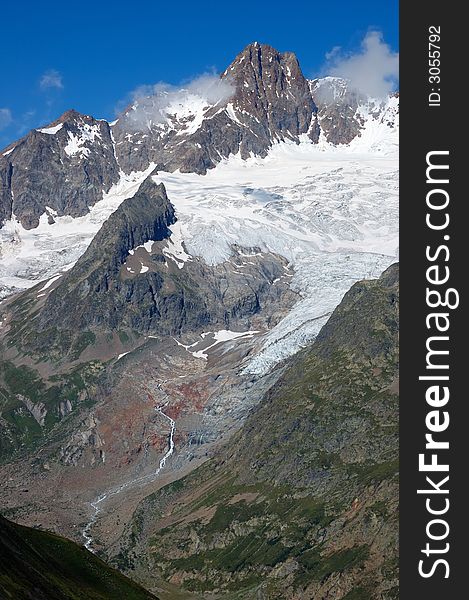 Mountain landscape: rocky peaks and big glaciers. Mont Blanc massif, Italy.