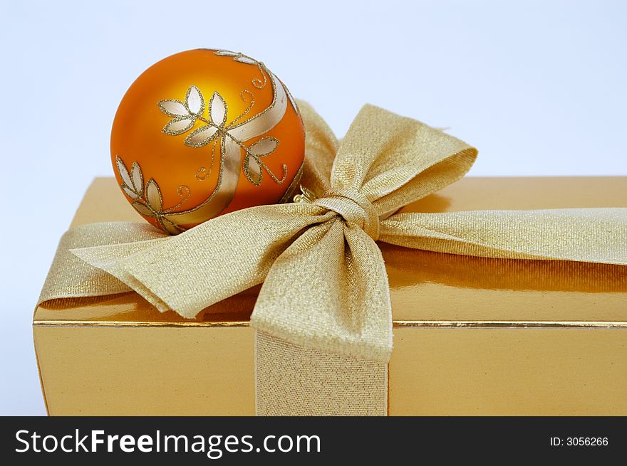 Gold christmas box and orange ball. Gold christmas box and orange ball