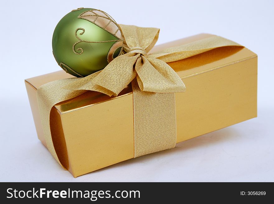 Gold christmas box and green ball. Gold christmas box and green ball