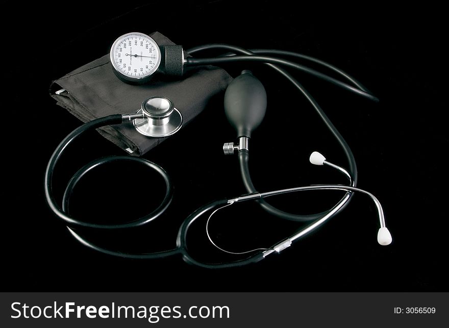 Sphygmomanometer and stethoscope taken on black cloth. Sphygmomanometer and stethoscope taken on black cloth