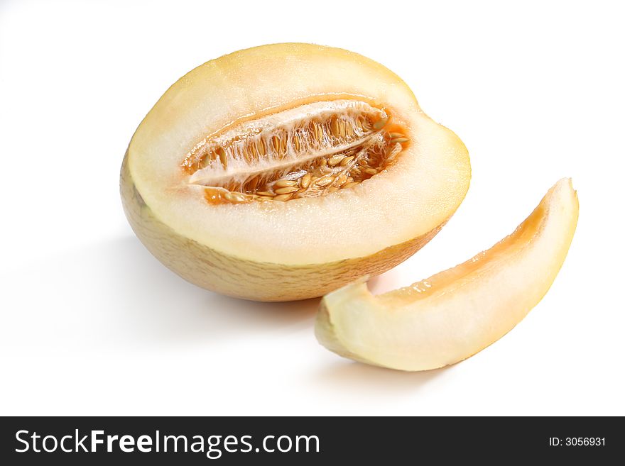 Ripe yellow melon and slice isolated over white. Ripe yellow melon and slice isolated over white