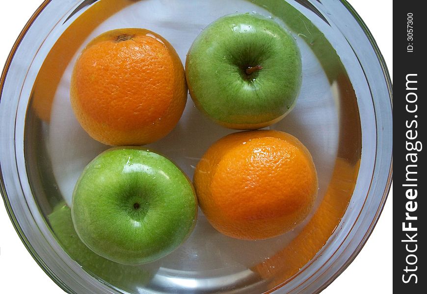 Apple and orange washing in glass plate. Apple and orange washing in glass plate