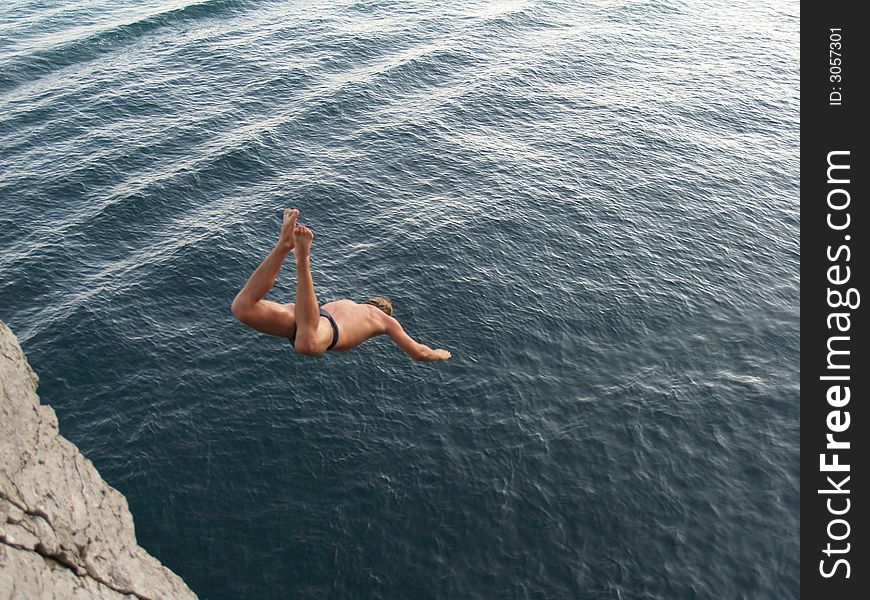 Teenage boy jumping into water. Teenage boy jumping into water