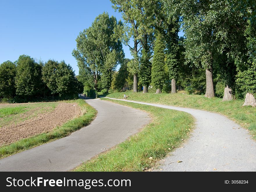 Footpath in the park.
	
beside the small river left in the picture.