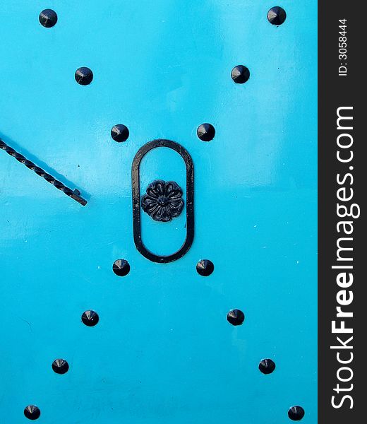 Turquoise metal door with traditional design