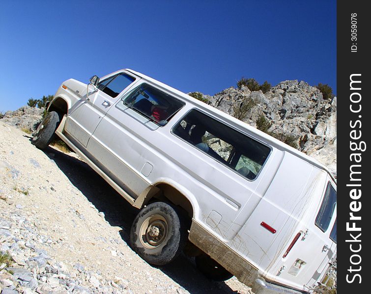 4x4 van on steep incline, exaggerated camera angle. 4x4 van on steep incline, exaggerated camera angle