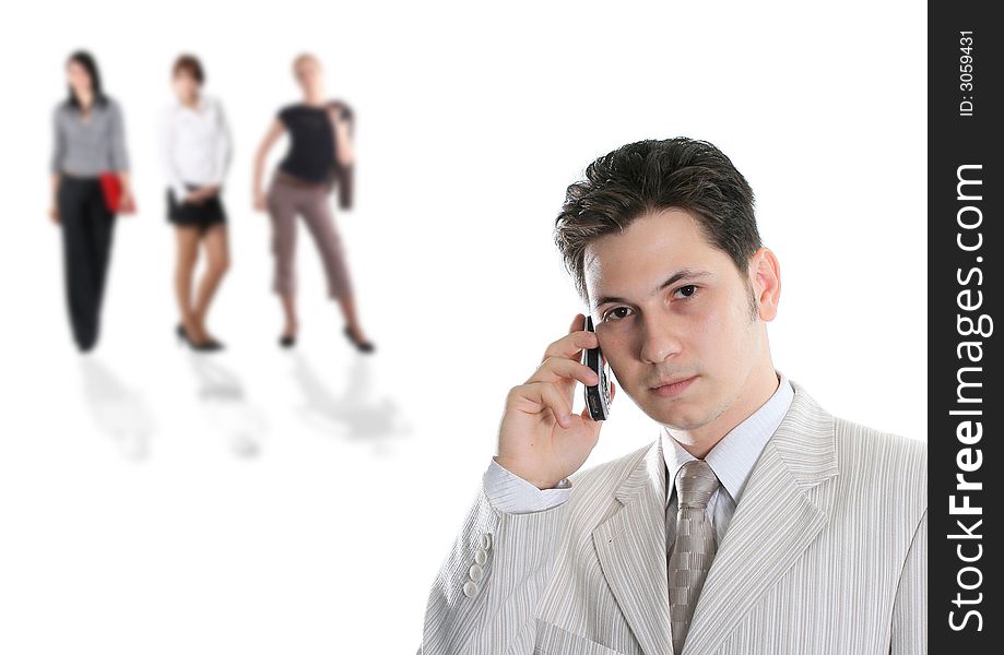 The young businessman with phone also three women on a back background. The young businessman with phone also three women on a back background