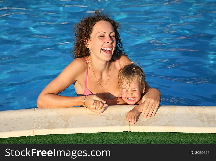 Mother with the child in the pond