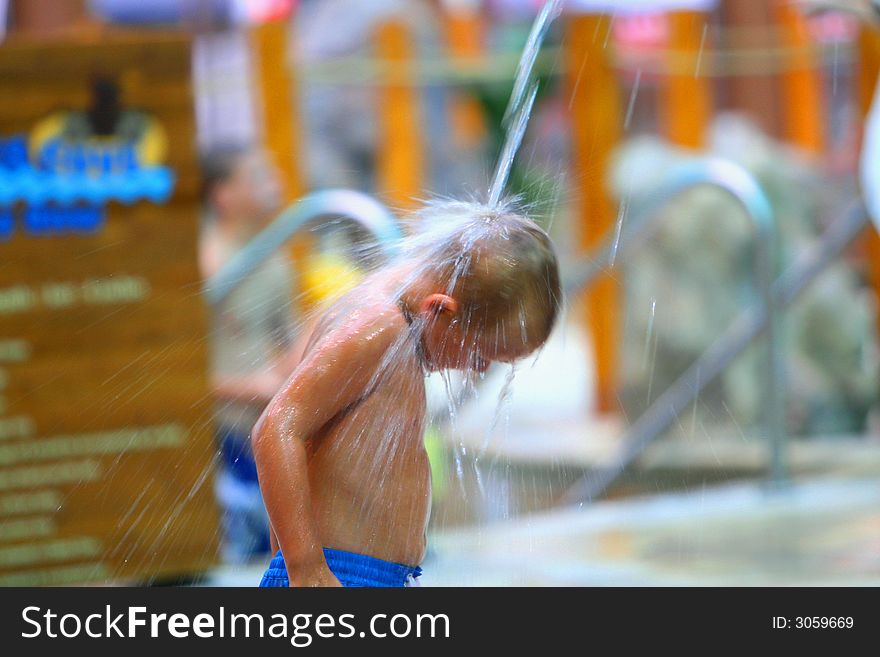 Boy in water park playing with water