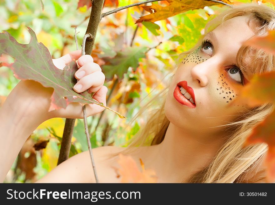 Teen is looking up in the forest