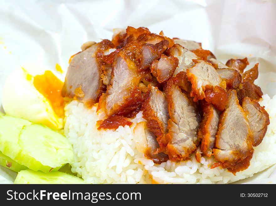 Rice with roasted red pork on the table