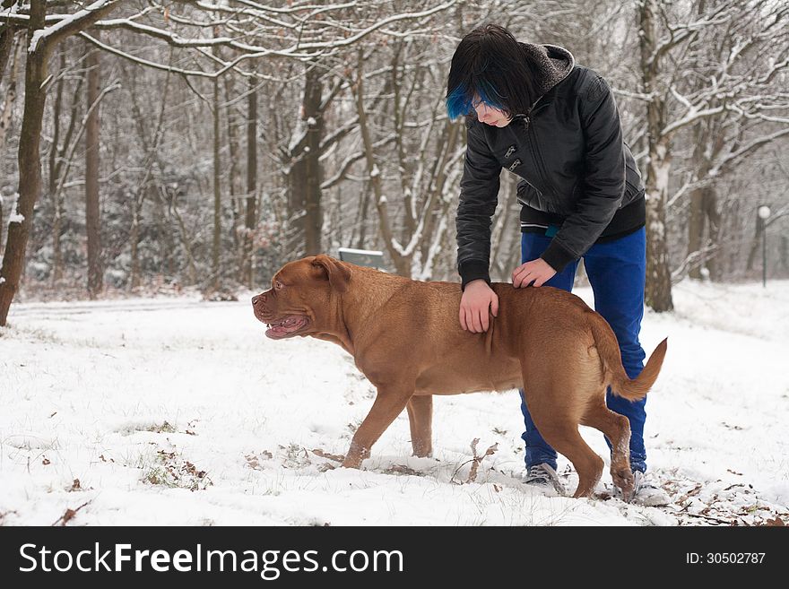 Funky boy is having fun with his dog in the snow. Funky boy is having fun with his dog in the snow
