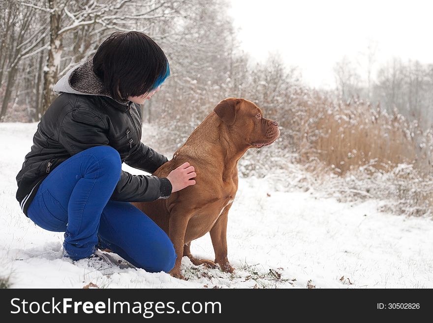 Funky boy is having fun with his dog in the snow. Funky boy is having fun with his dog in the snow