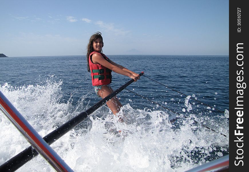 Portrait of a cheerful young girl water skiing. Portrait of a cheerful young girl water skiing