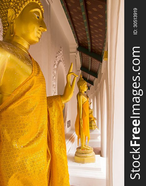 Golden Buddha statues at the curved balcony of the temple