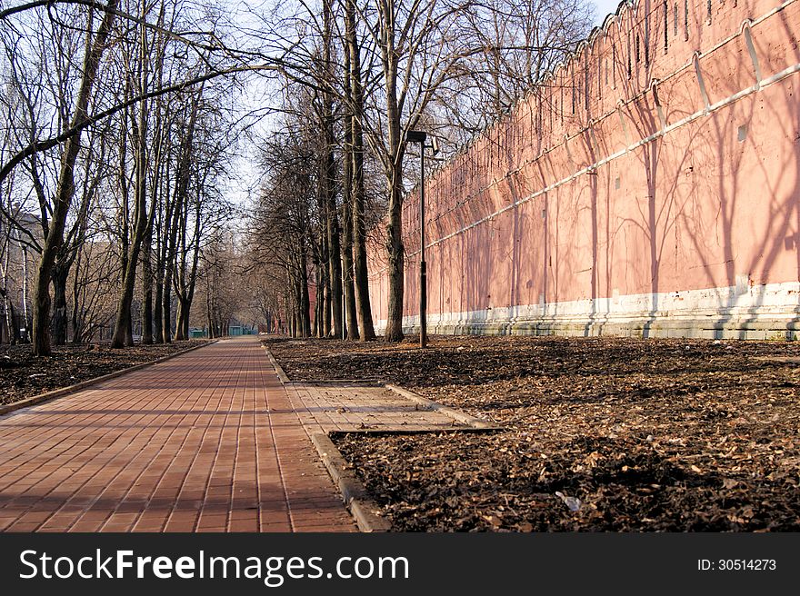 The fortress wall of the monastery in the old part of the city of Moscow