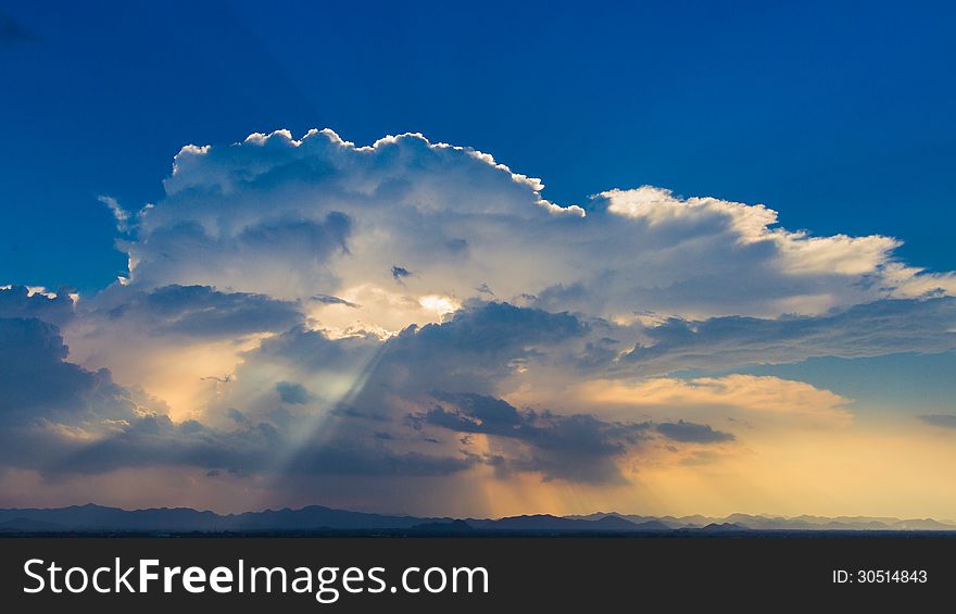 Sun rays on blue sky over the mountain