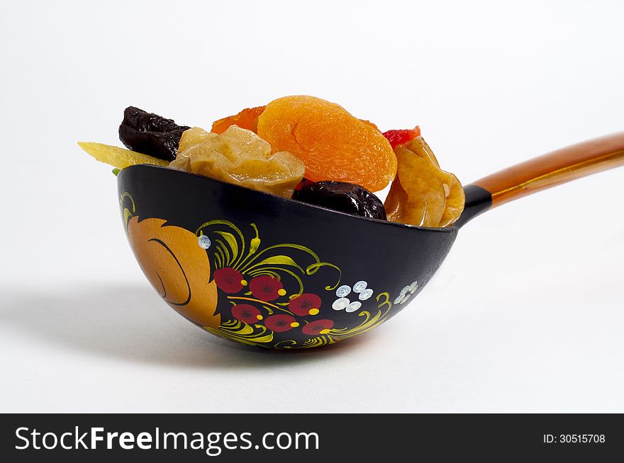 Spoon with fruit on a white background