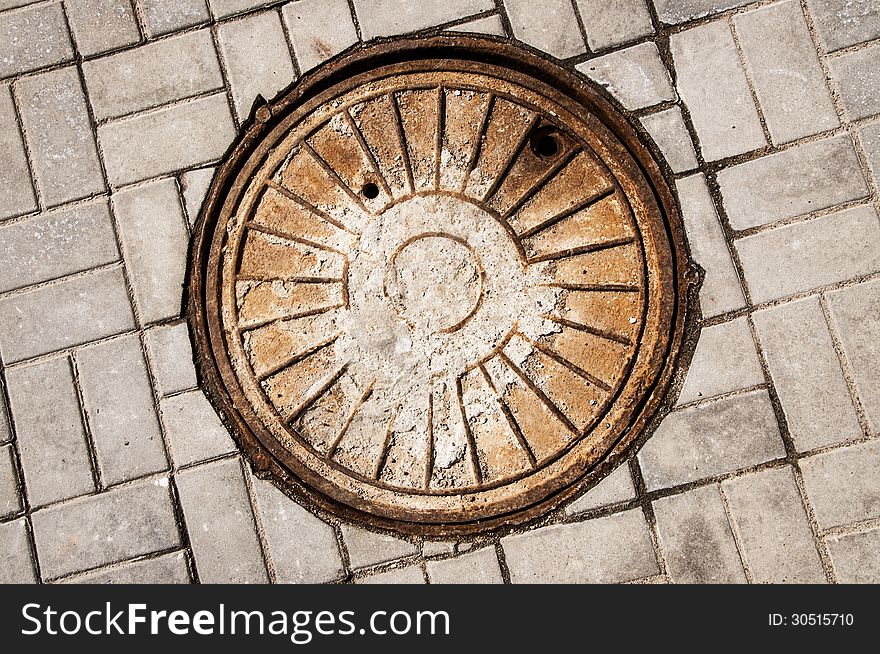 Rusty manhole on road. close-up.