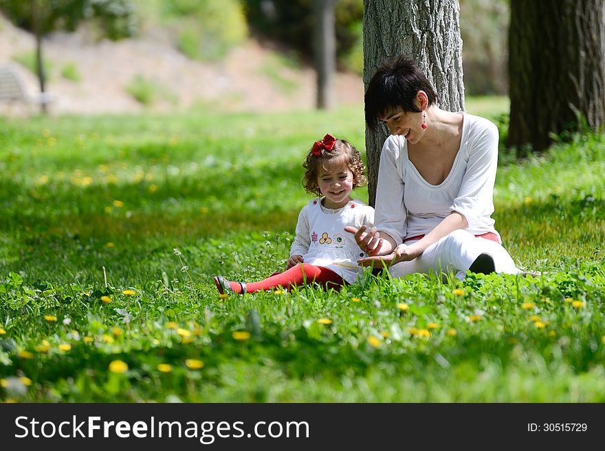 Portrait of mother and little girl playing in the park