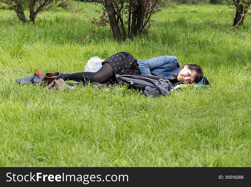 Girl resting on grass in the middle of spring