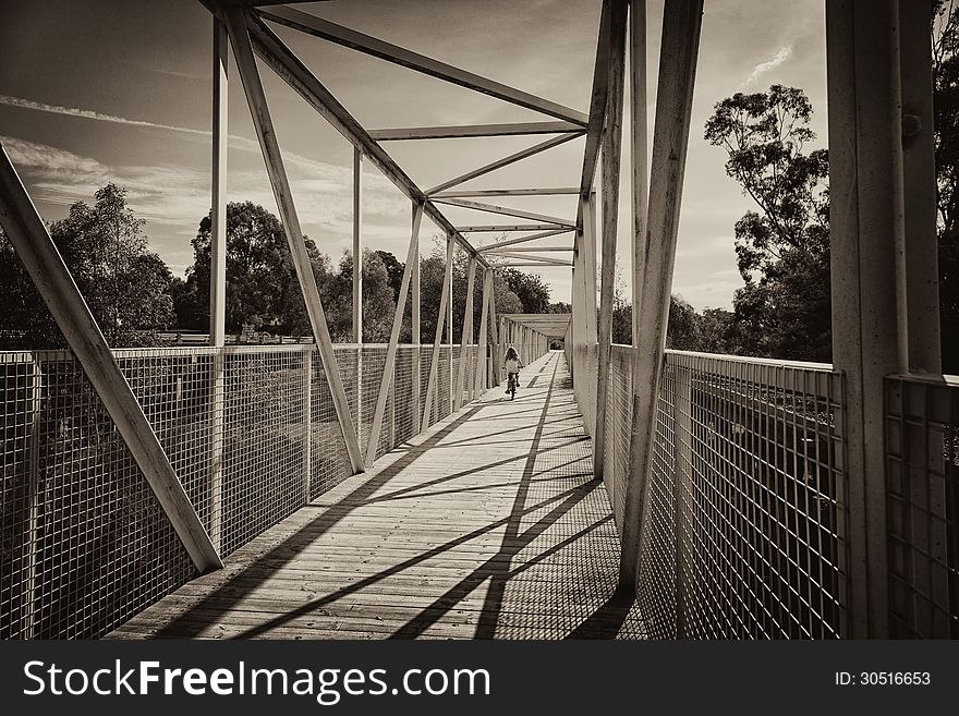 A child riding a bike along a bridge in Koonwarra, Australia.