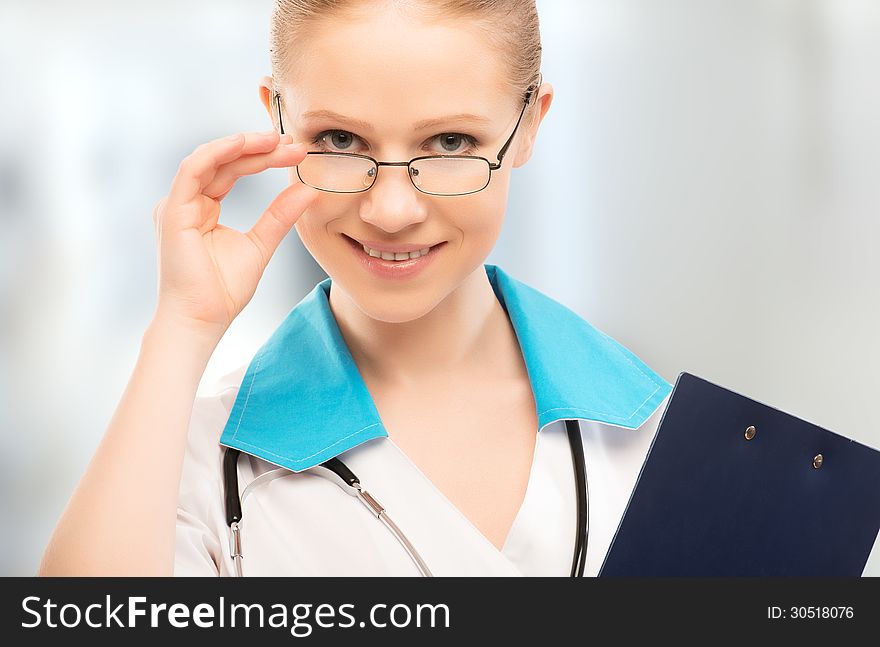 Friendly woman doctor smiling with folder in hand