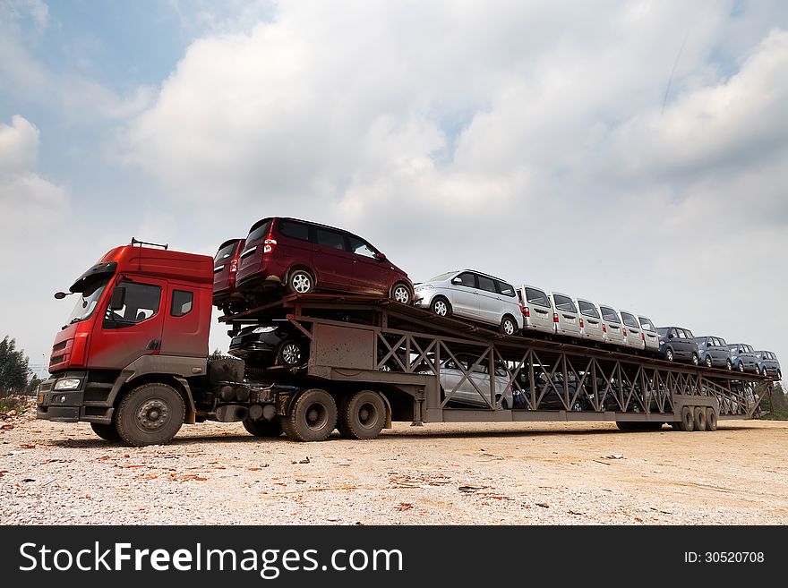 New cars in a oversize vehicle waitting for shipping. New cars in a oversize vehicle waitting for shipping
