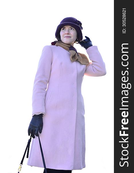 Elegant female in pink coat on a white background. isolated