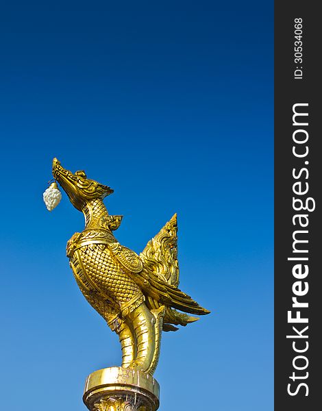 Statuary gold bird  on blue sky