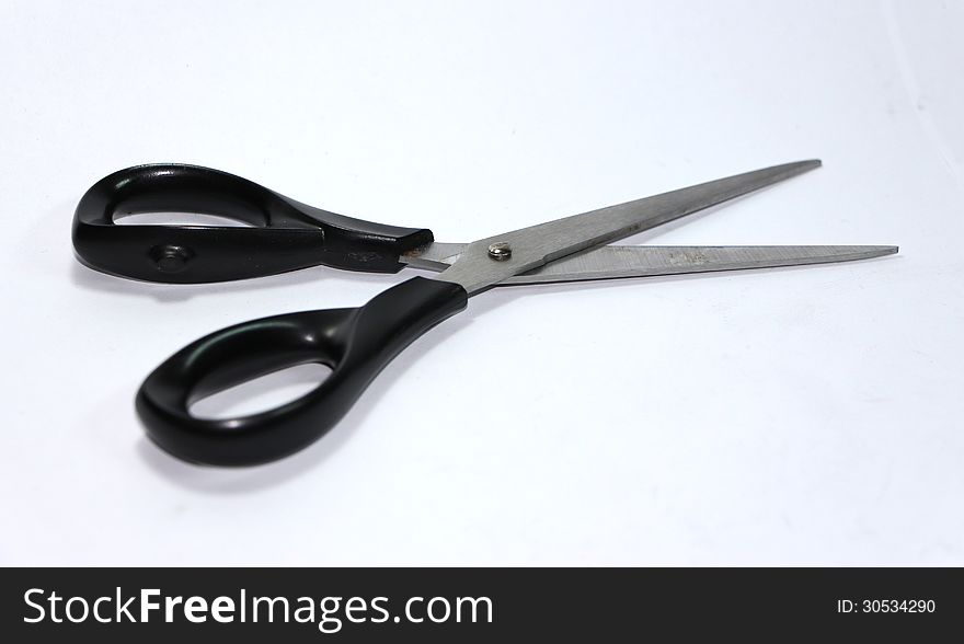 The black scissors is used to cut something.