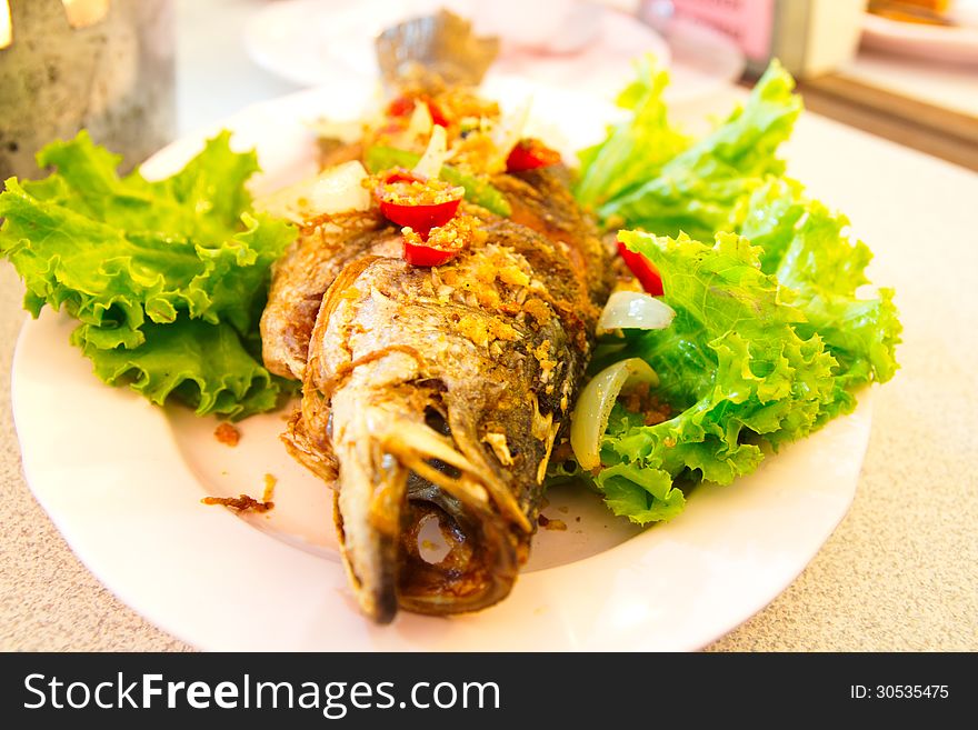 Fired fish with fresh herds delicious Thai food. Fired fish with fresh herds delicious Thai food