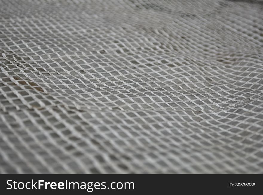 Light Wicker Grille On A Gray Background.