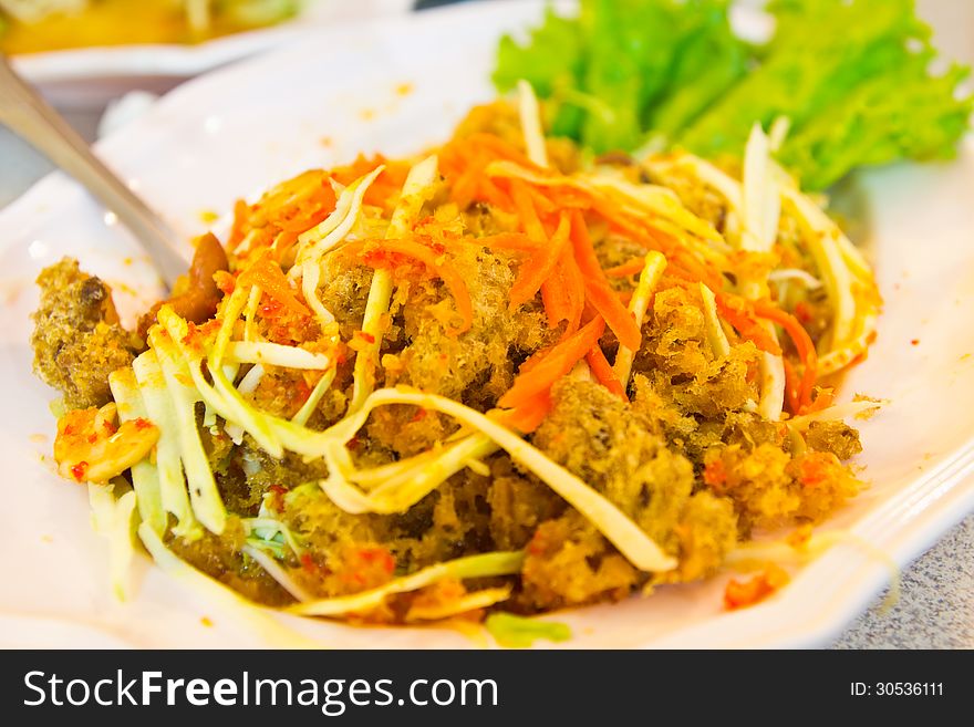 Spicy fried Thai tilapia fish salad minced meat with vegetable,thai food. Spicy fried Thai tilapia fish salad minced meat with vegetable,thai food