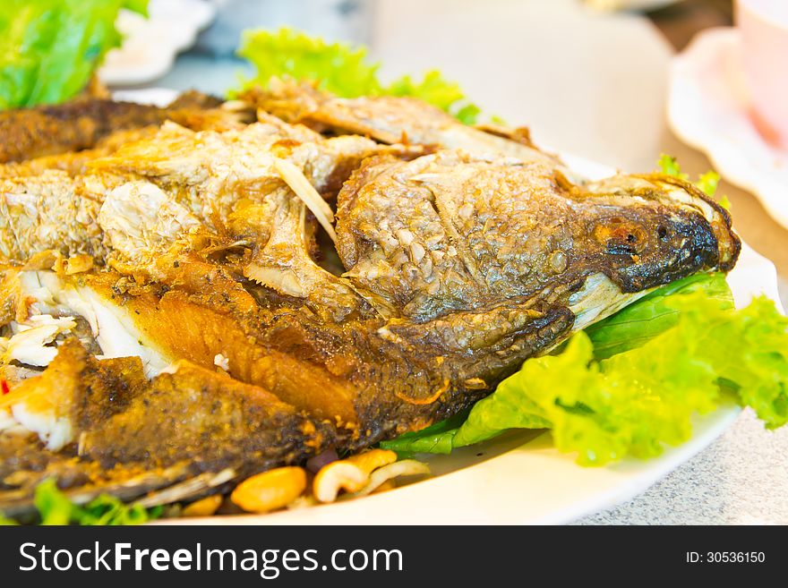 Fired fish with fresh herds delicious Thai food. Fired fish with fresh herds delicious Thai food