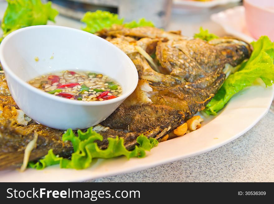 Fried Fish on dish with vegetables and pepper Sauce,Style Thailand. Fried Fish on dish with vegetables and pepper Sauce,Style Thailand