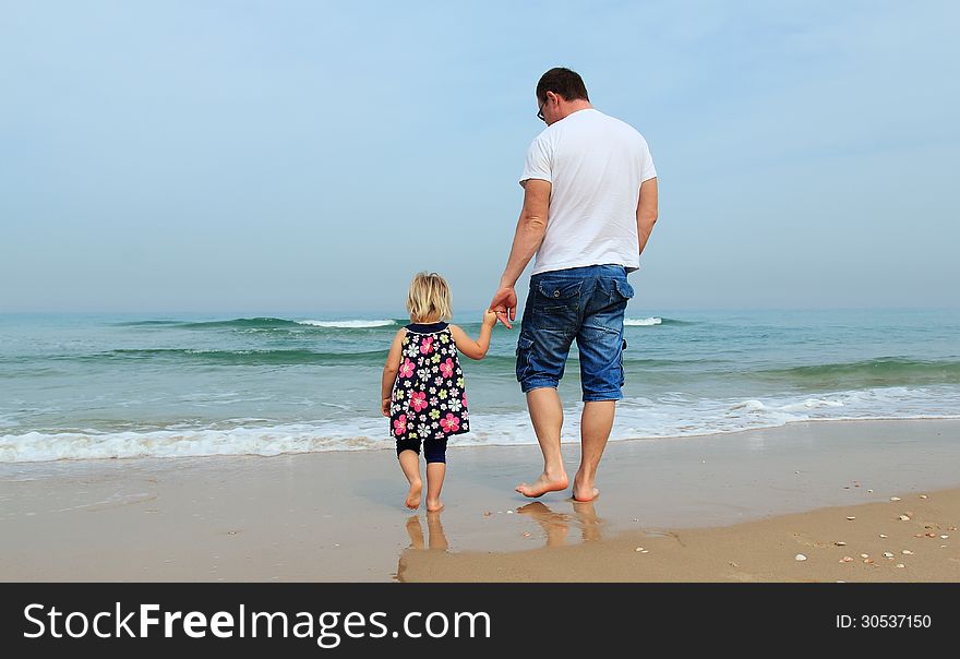 Father and daughter on the beach