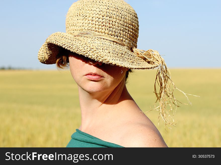 Pretty woman in the hat in golden wheat. Pretty woman in the hat in golden wheat