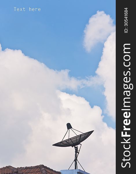 Satellite Dish And Cloudy Blue Sky