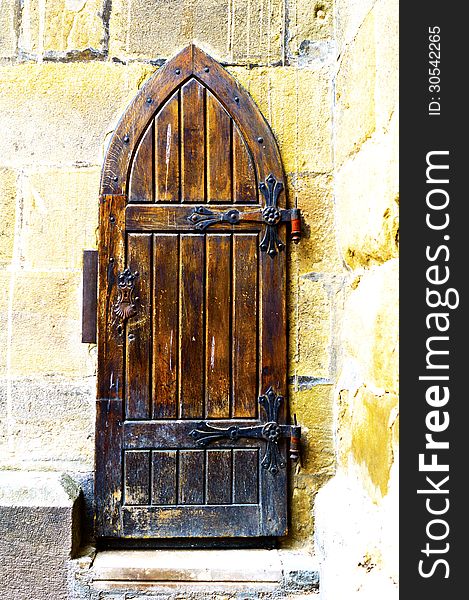 Wooden medieval church door with iron hingies