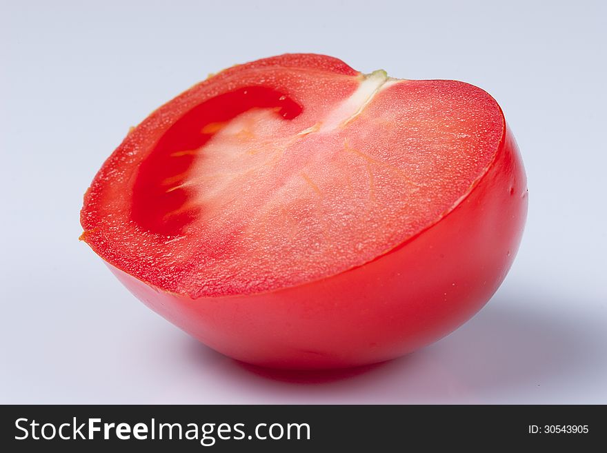 Tomato cut in half on white background