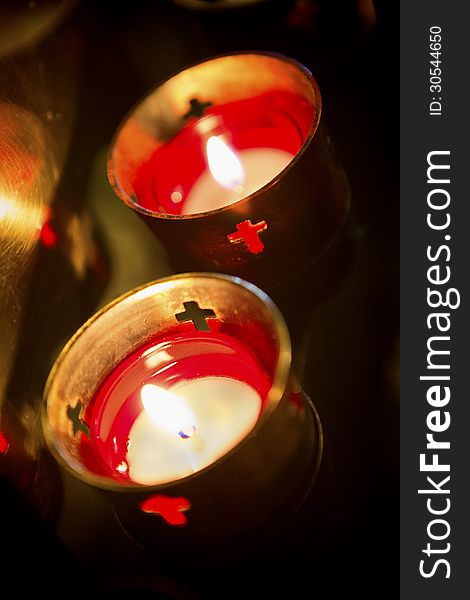 Devotional candles lighting a darkened Basilica of the National Shrine of Mary, Queen of the Universe. Devotional candles lighting a darkened Basilica of the National Shrine of Mary, Queen of the Universe.