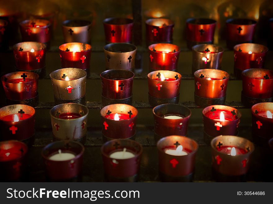 Devotional candles lighting a darkened Basilica of the National Shrine of Mary, Queen of the Universe. Devotional candles lighting a darkened Basilica of the National Shrine of Mary, Queen of the Universe.