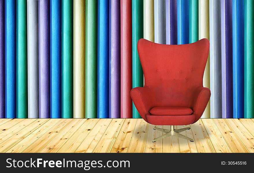 Red chair on colorful wall background